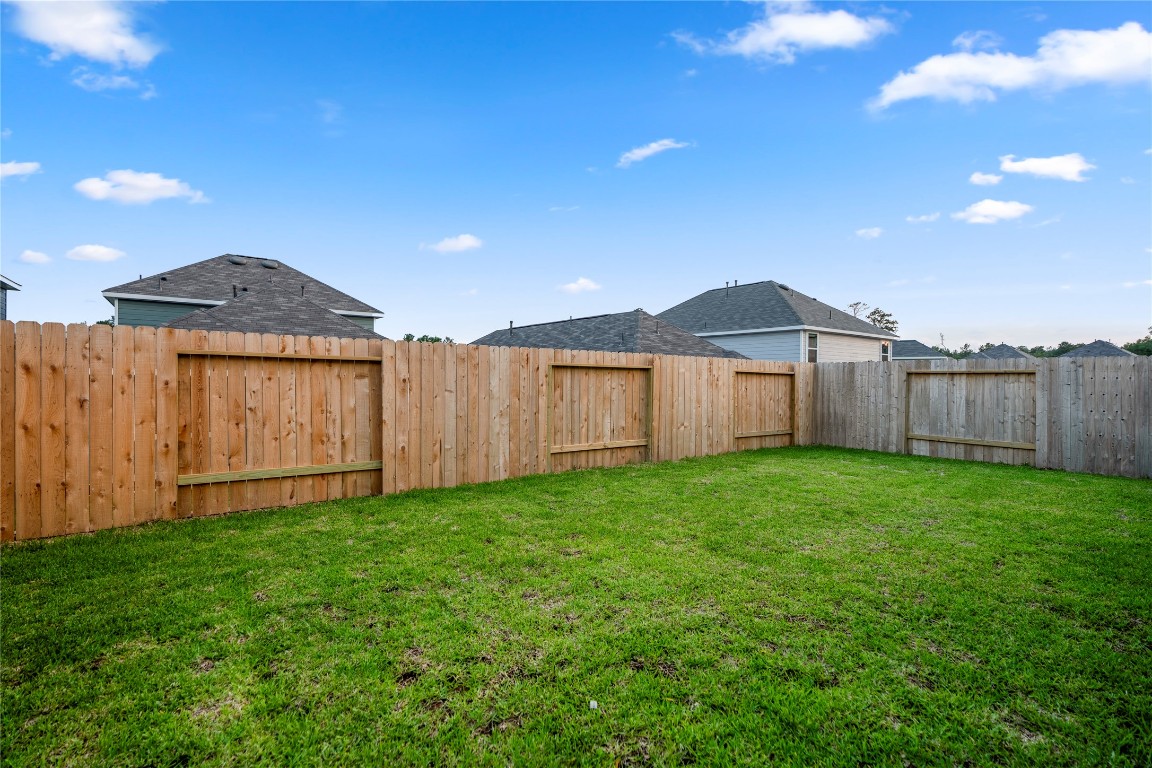 2421 Shellcracker Drive Conroe, TX 77384 - Photo 39 of 43 a view of a backyard with wooden fence