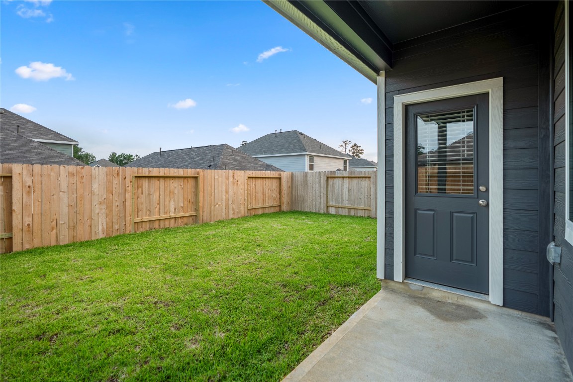 2421 Shellcracker Drive Conroe, TX 77384 - Photo 40 of 43 a view of a backyard with a garden