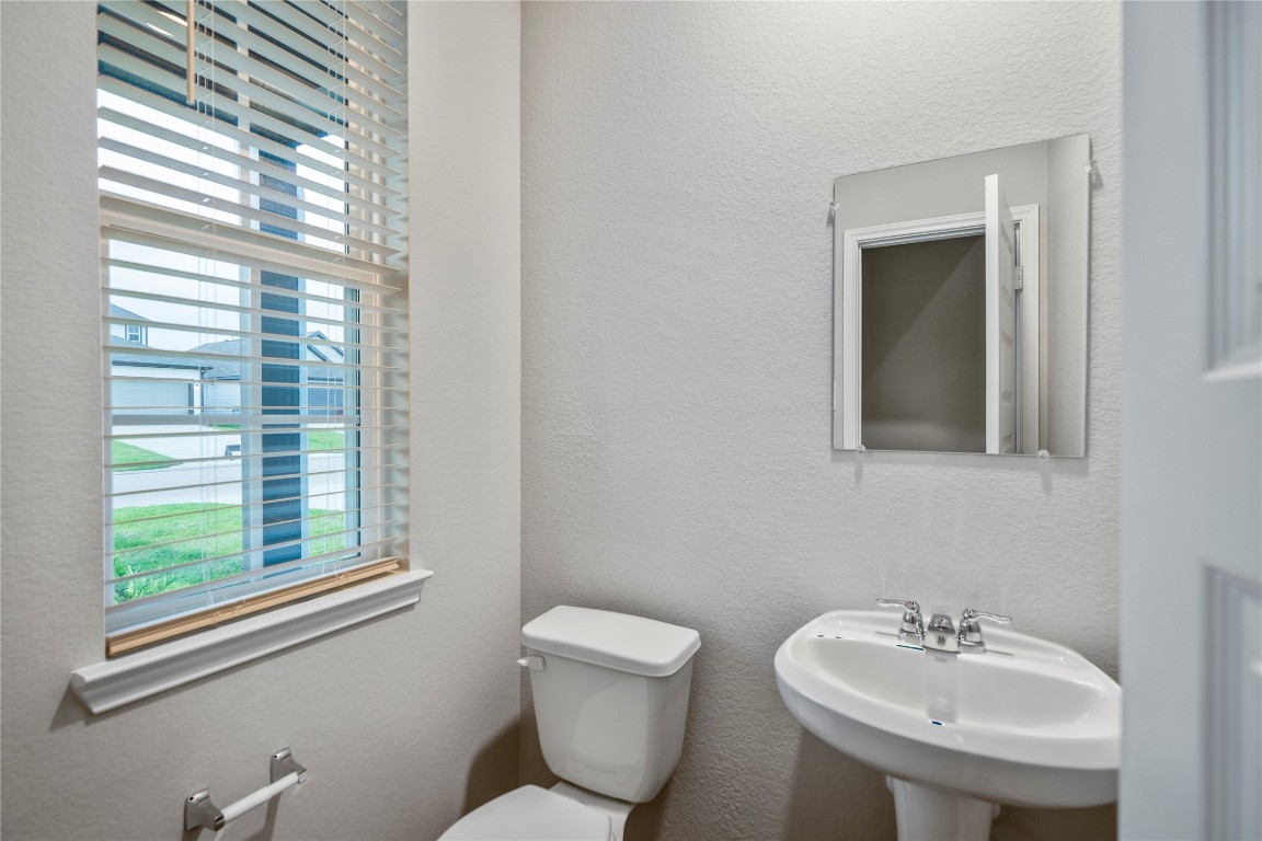 2421 Shellcracker Drive Conroe, TX 77384 - Photo 8 of 43 a bathroom with a toilet sink and mirror
