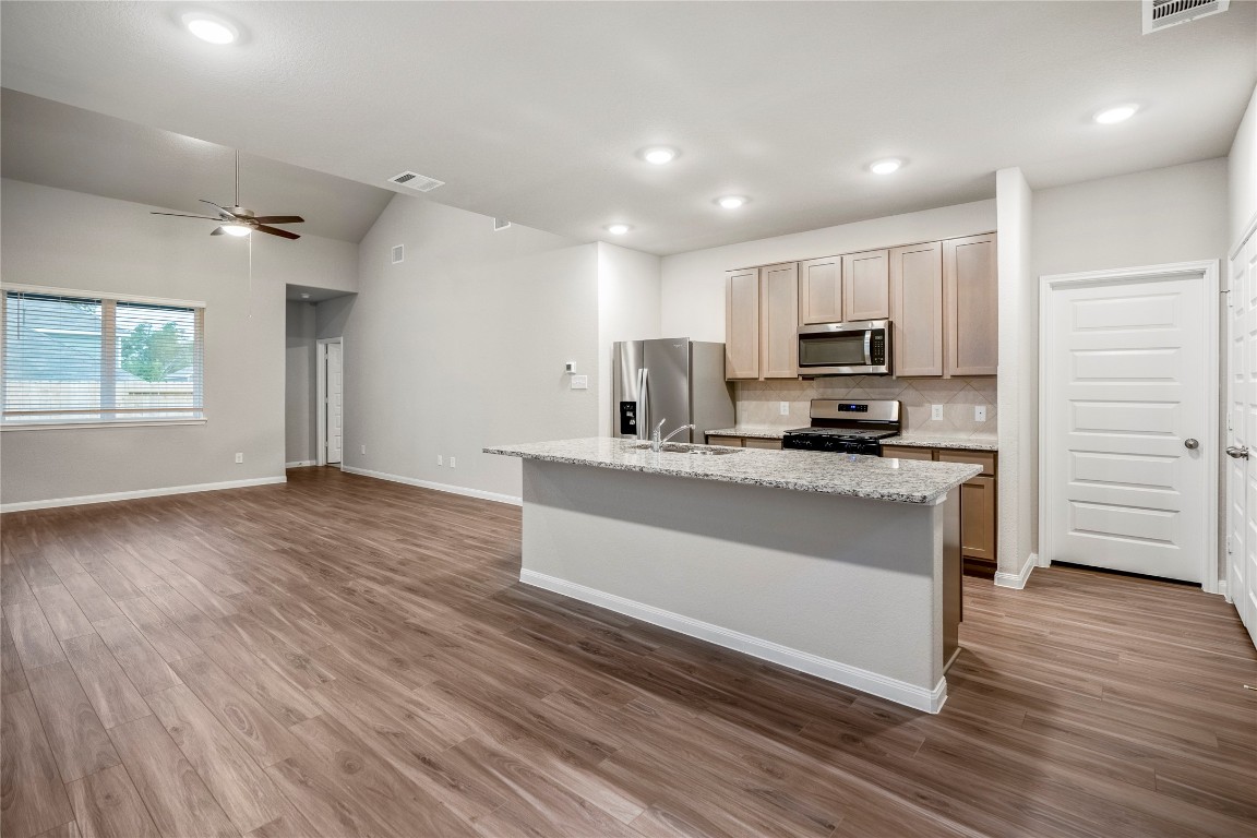 2421 Shellcracker Drive Conroe, TX 77384 - Photo 10 of 43 a kitchen with stainless steel appliances a refrigerator and a stove top oven