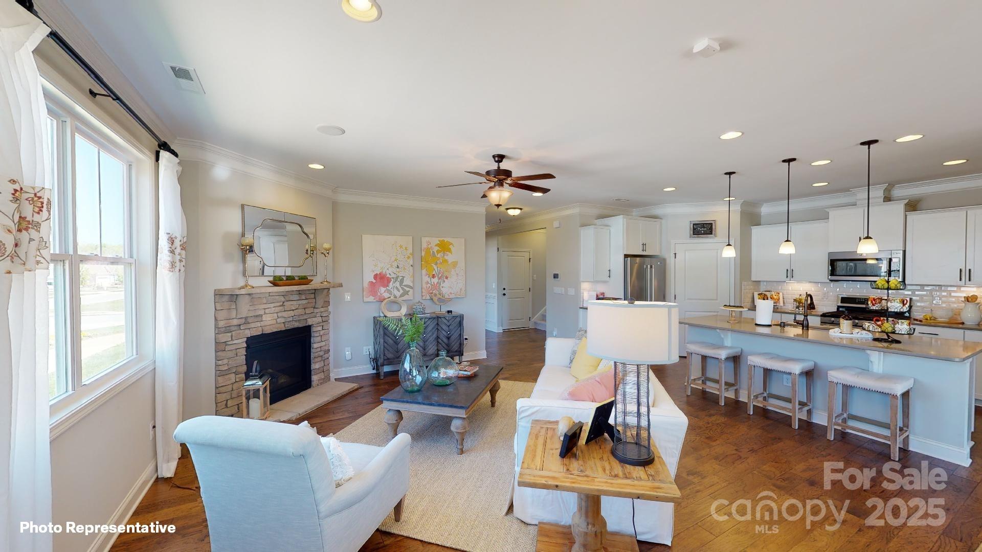 112 Noah Lane Troutman, NC 28166 - Photo 11 of 27 a living room with furniture kitchen view and a fireplace