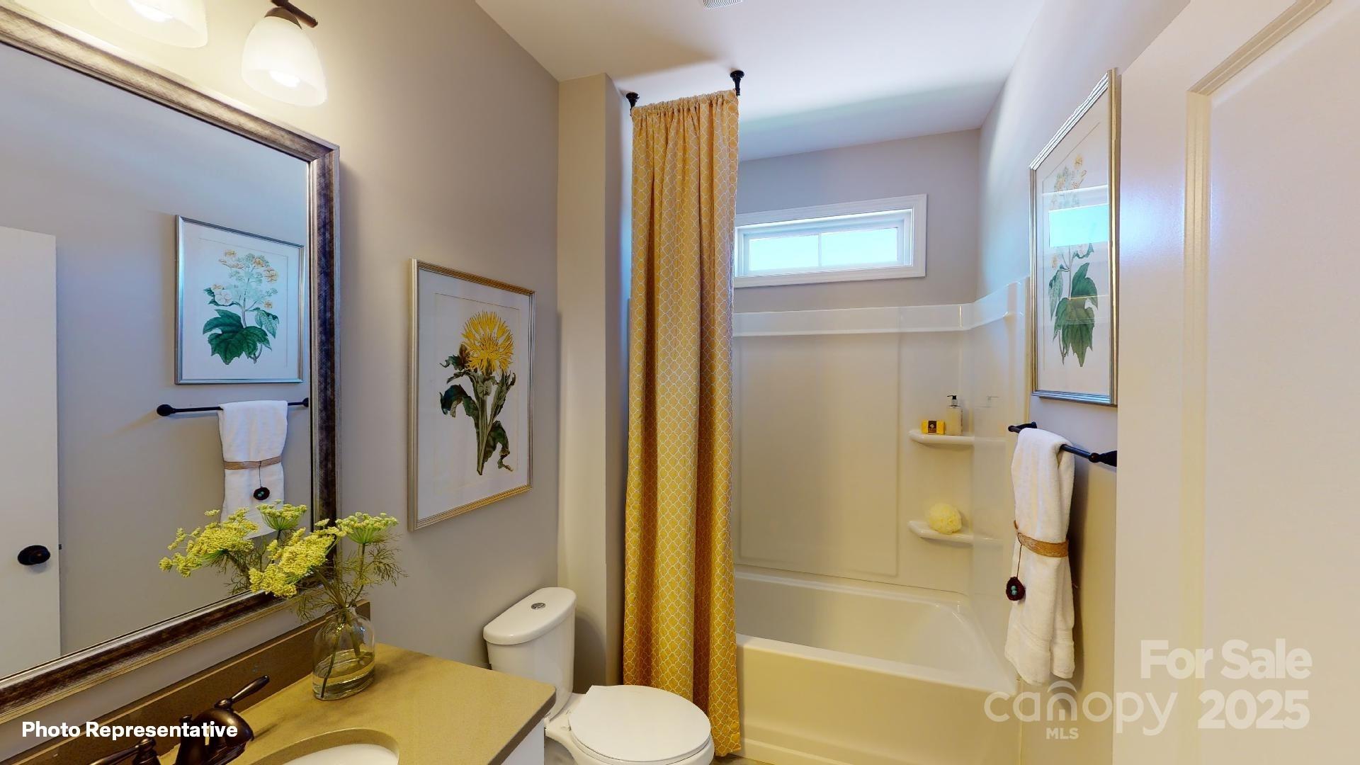 112 Noah Lane Troutman, NC 28166 - Photo 13 of 27 a white toilet sitting next to a bathroom sink and a shower