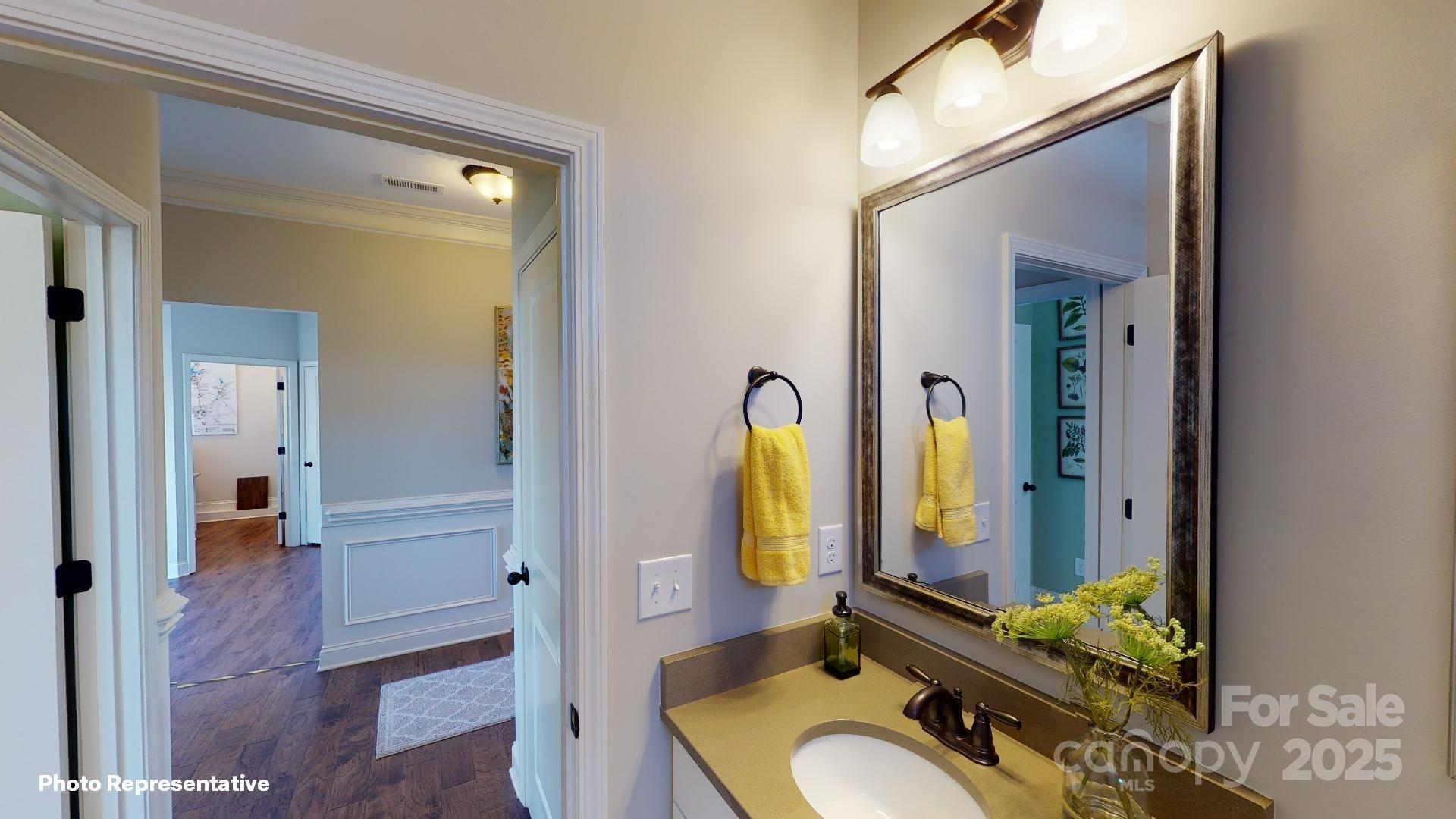 112 Noah Lane Troutman, NC 28166 - Photo 14 of 27 a bathroom with a granite countertop sink a mirror and a shower