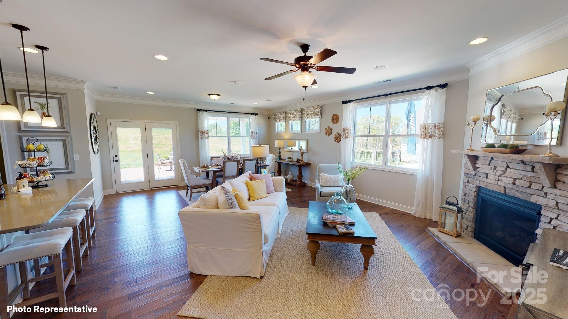 112 Noah Lane Troutman, NC 28166 - Photo 17 of 27 a living room with fireplace furniture and a wooden floor