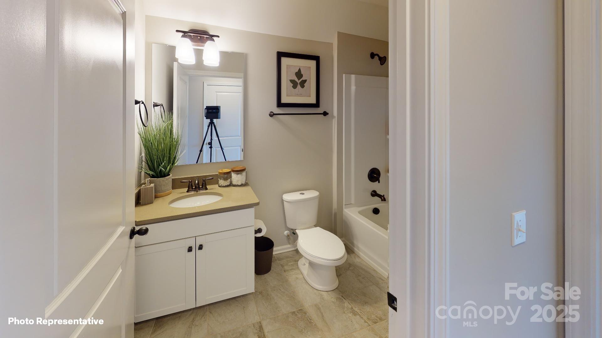 112 Noah Lane Troutman, NC 28166 - Photo 19 of 27 a bathroom with a toilet a sink and mirror