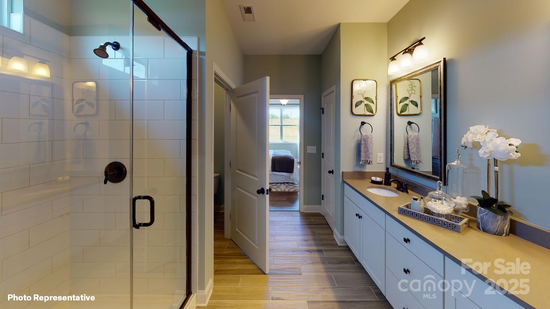 112 Noah Lane Troutman, NC 28166 - Photo 20 of 27 a bathroom with a double vanity sink and a mirror