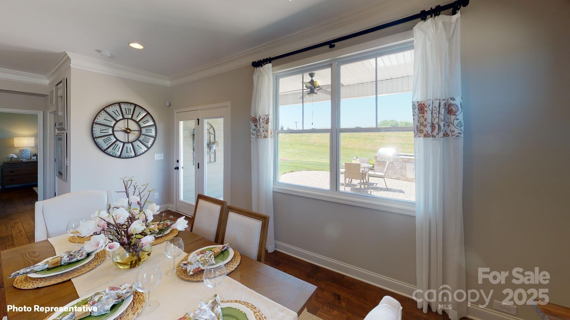 112 Noah Lane Troutman, NC 28166 - Photo 25 of 27 a view of a dining room with furniture window and wooden floor