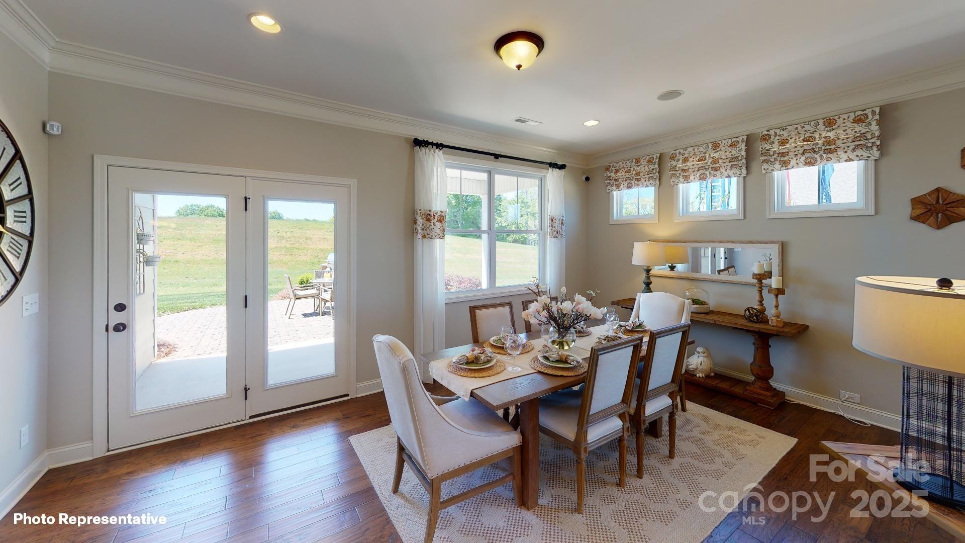 112 Noah Lane Troutman, NC 28166 - Photo 26 of 27 a dining room with furniture and wooden floor