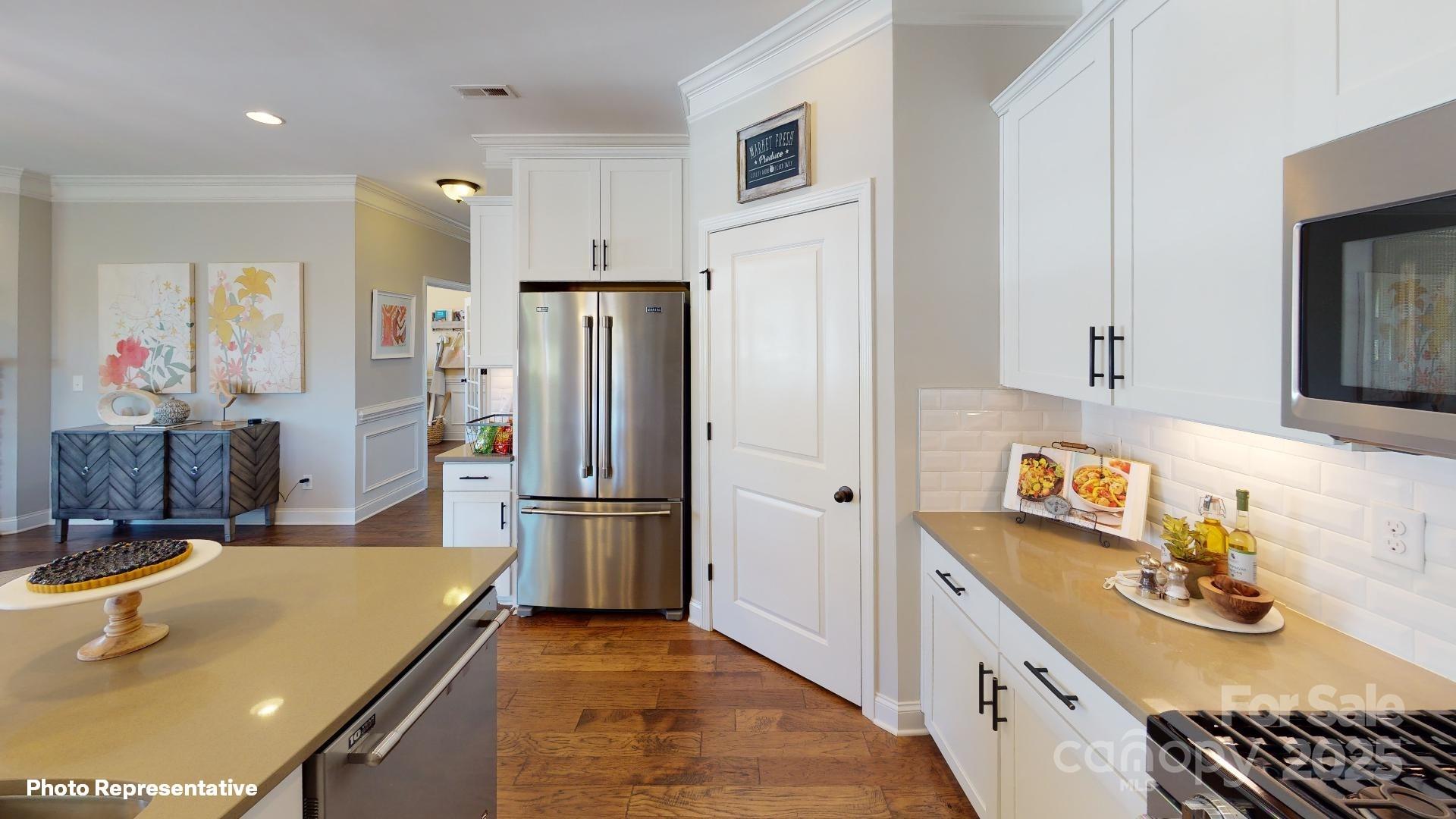 112 Noah Lane Troutman, NC 28166 - Photo 27 of 27 a kitchen with refrigerator and stove