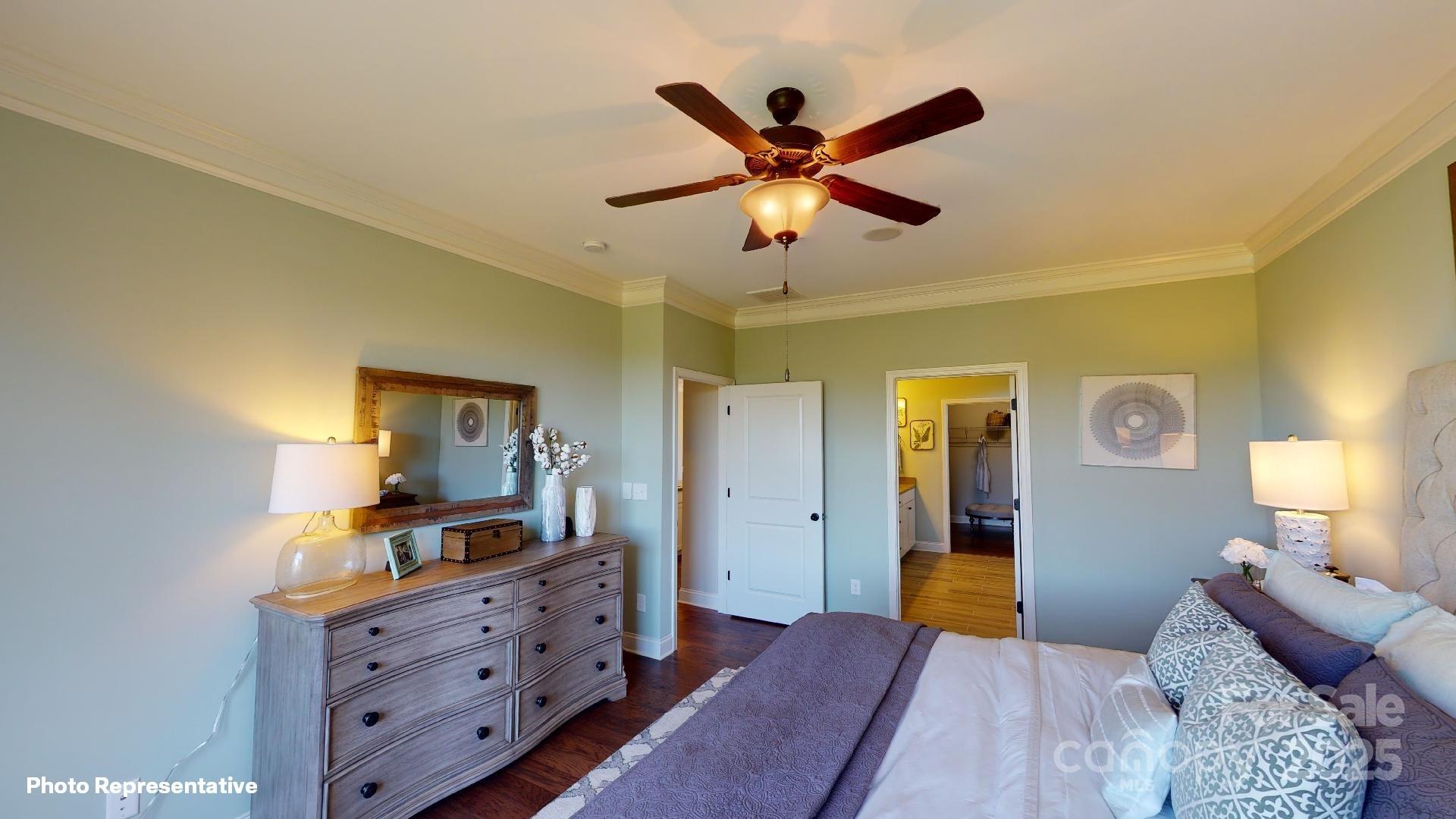 112 Noah Lane Troutman, NC 28166 - Photo 7 of 27 a bedroom with a bed and furniture