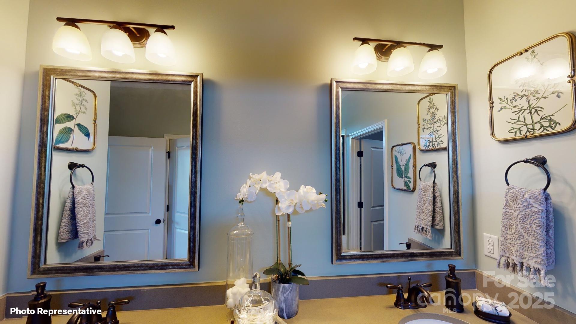 112 Noah Lane Troutman, NC 28166 - Photo 8 of 27 a bathroom with mirror and sink