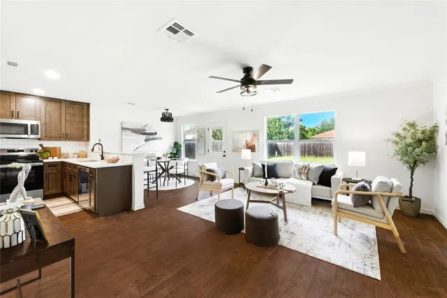 a living room with furniture kitchen and a window