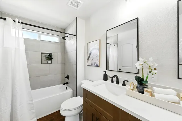 a living room with furniture a fireplace and a large window