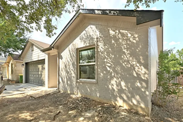 a bathroom with a granite countertop sink toilet tub and shower