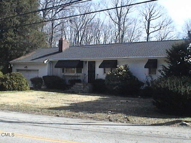 a house that has a tree in front of it