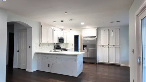 a kitchen with stainless steel appliances a refrigerator sink and cabinets