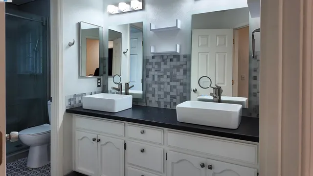 a bathroom with a double vanity sink and mirror