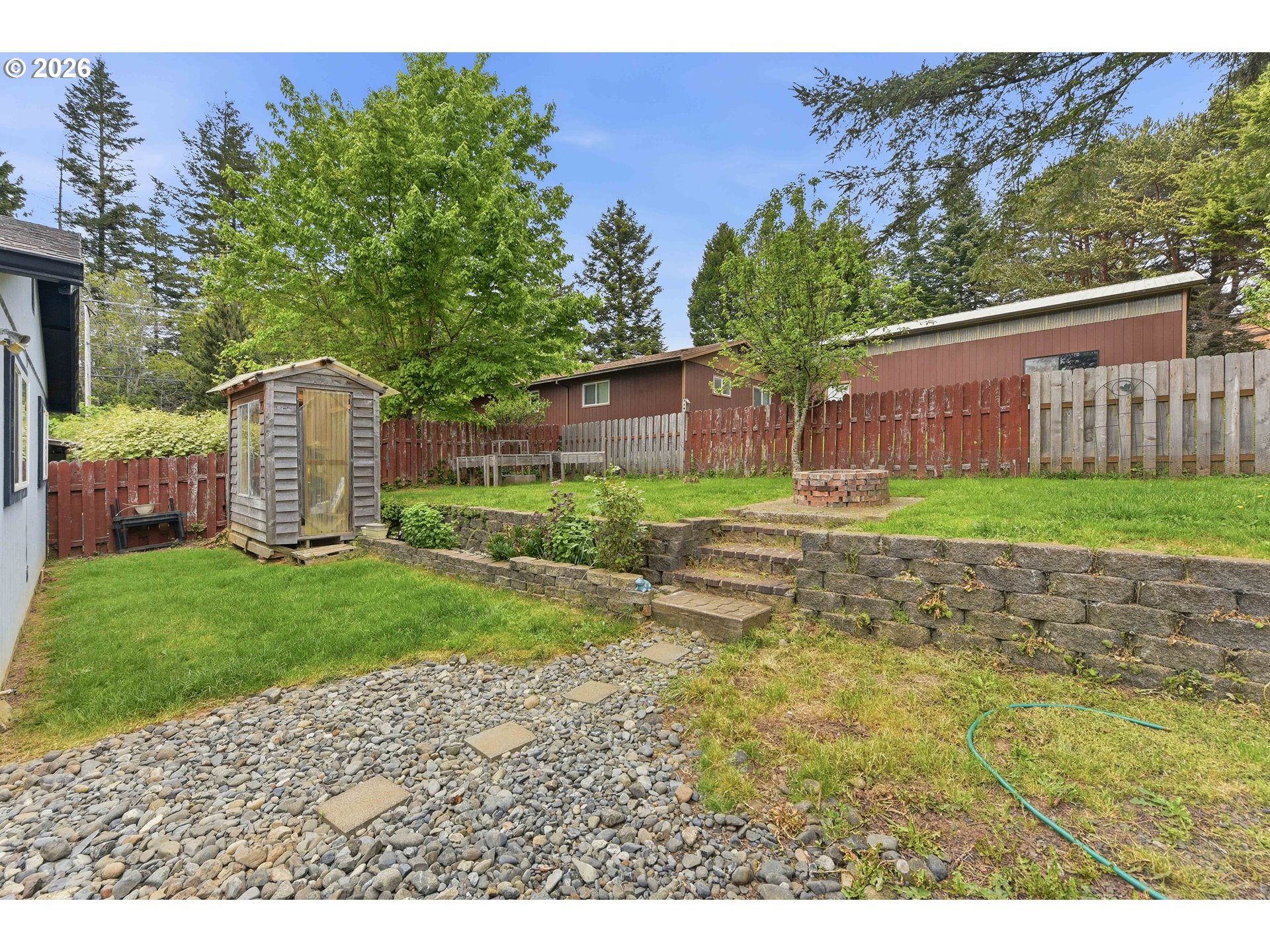 192 North Wood Ridge Road Coquille, OR 97423 - Photo 40 of 42 a backyard of a house with lots of green space