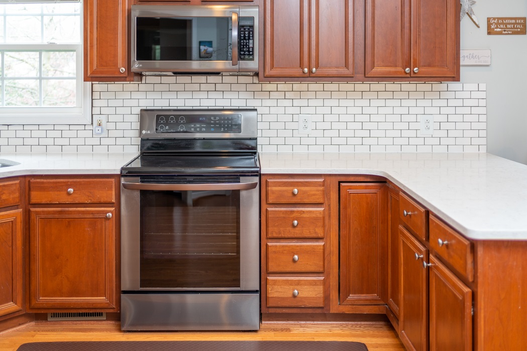 69 Sir Robin Road Waynesboro, VA 22980 - Photo 8 of 32 a kitchen with granite countertop cabinets and black stainless steel appliances