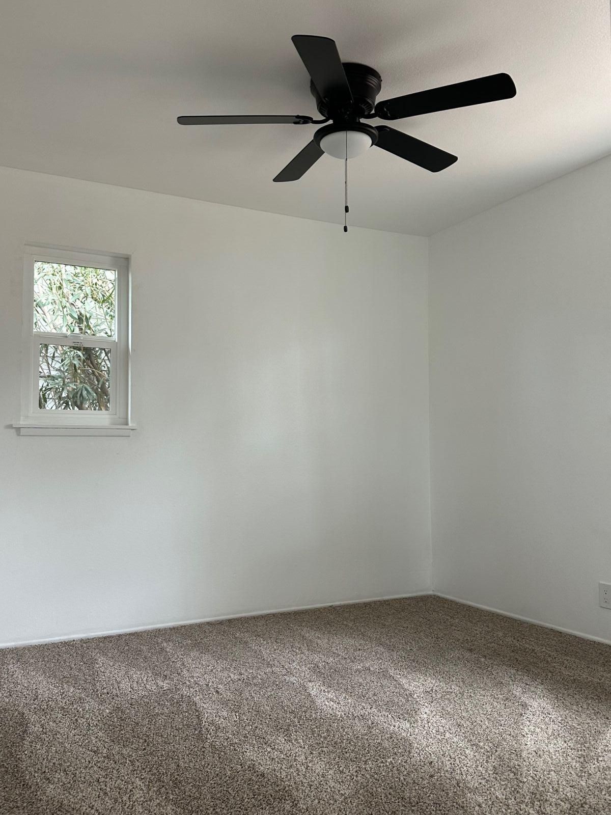 237 South Fire Opal Street Ridgecrest, CA 93555 - Photo 8 of 9 an empty room with a ceiling fan and window