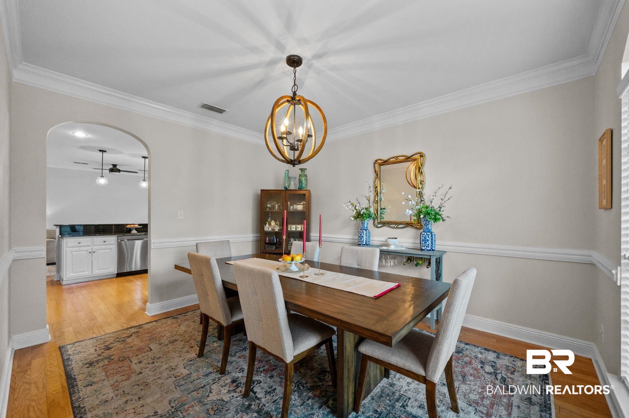 1825 Spring Hill Avenue Mobile, AL 36607 - Photo 6 of 43 Dining space with crown molding, light wood finished floors, arched walkways, and a chandelier