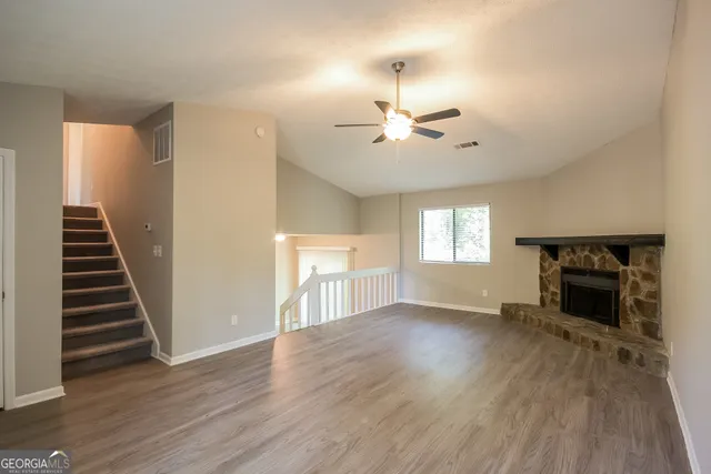 wooden floor in an empty room with a fireplace