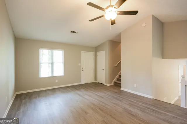 wooden floor in an empty room with a window