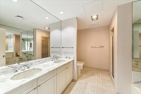 a bathroom with a tub sink and mirror