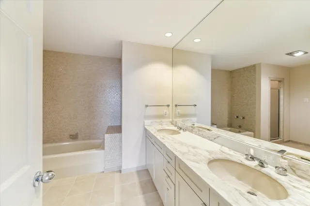 a bathroom with a bathtub and shower