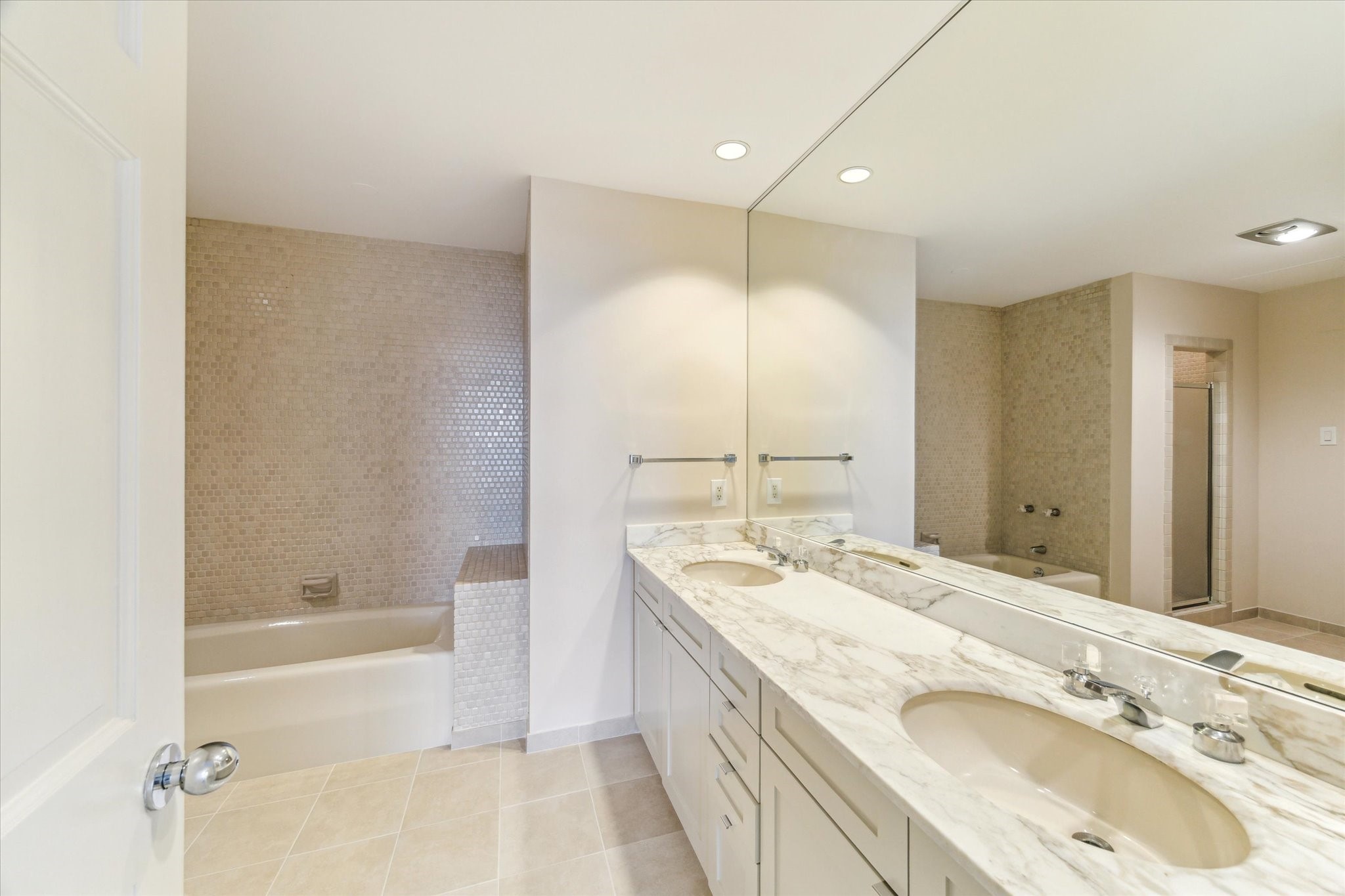 1111 Hermann Drive, Unit 7F Houston, TX 77004 - Photo 22 of 42 a bathroom with a granite countertop sink mirror and a bath tub