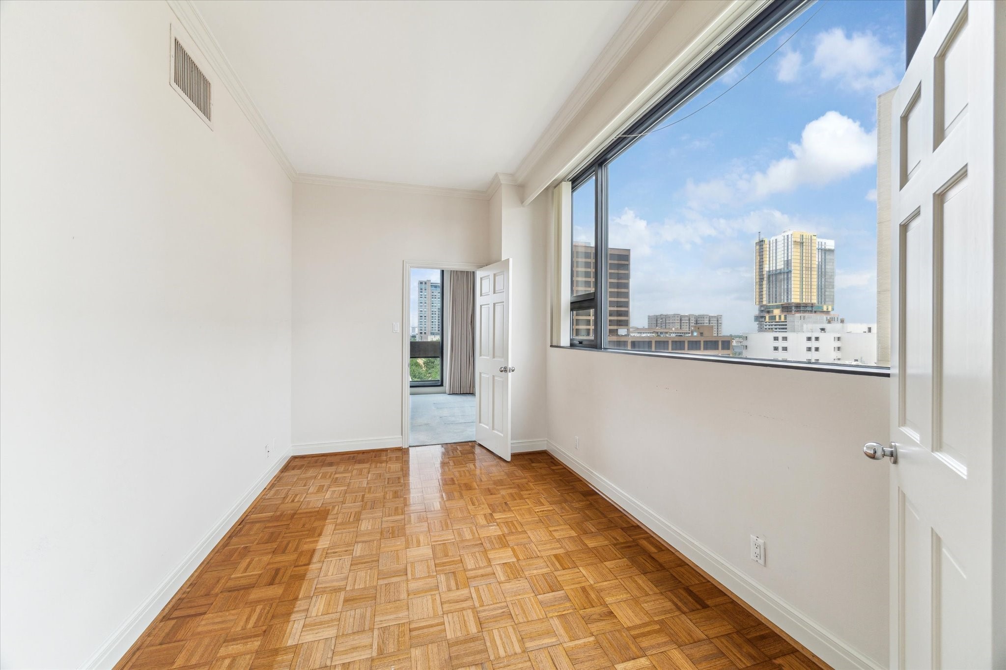 1111 Hermann Drive, Unit 7F Houston, TX 77004 - Photo 25 of 42 a view of an empty room with a window