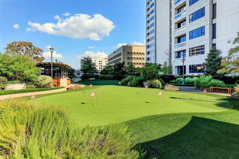 a view of swimming pool with seating area and lake view