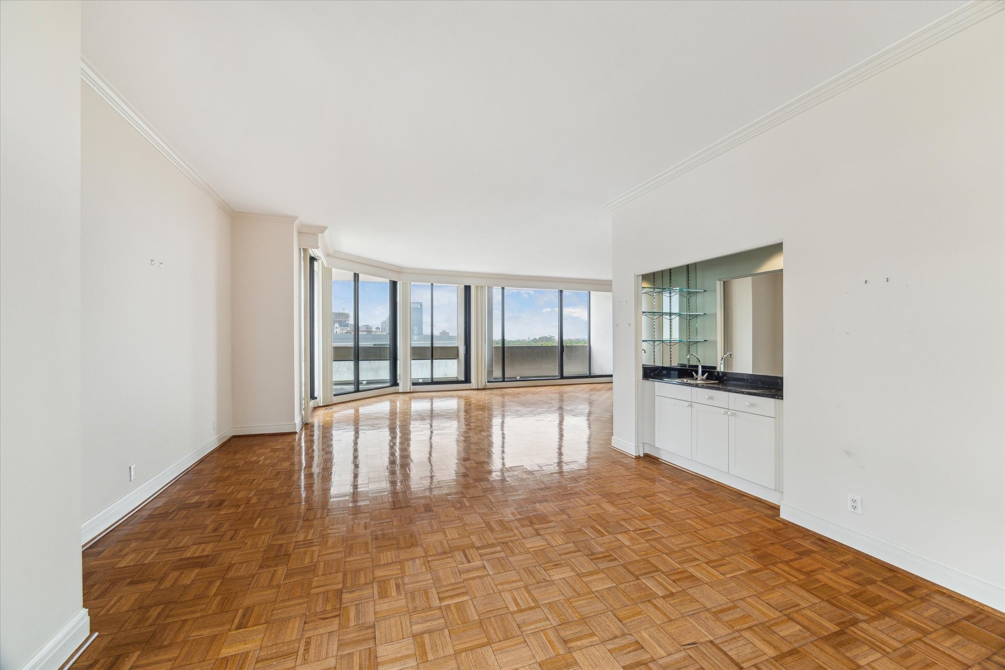 1111 Hermann Drive, Unit 7F Houston, TX 77004 - Photo 6 of 42 a view of an empty room with wooden floor and a window