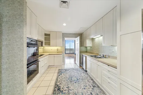 a kitchen with stainless steel appliances kitchen island granite countertop a sink and cabinets