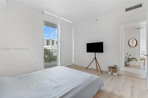 a bedroom with a bed and glass window