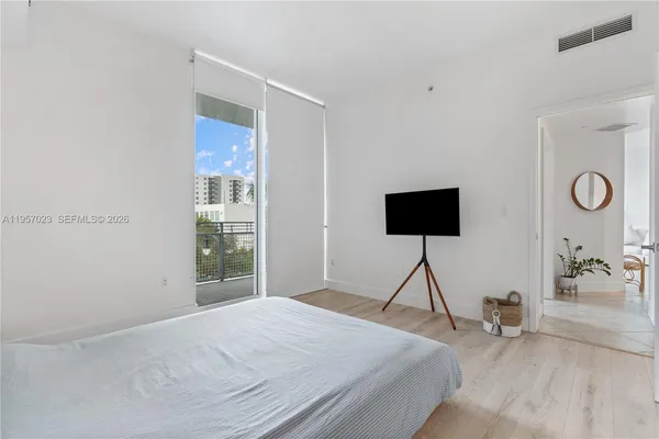 a bedroom with a bed and glass window