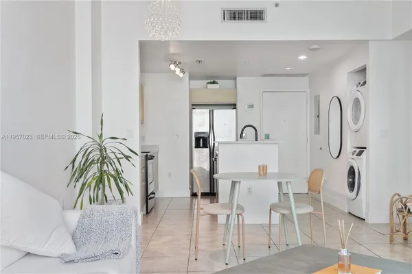 a dining room with furniture and floor to ceiling window