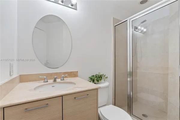 a bathroom with a sink toilet and shower