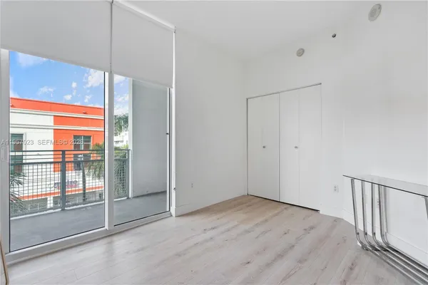 a view of an empty room with glass door