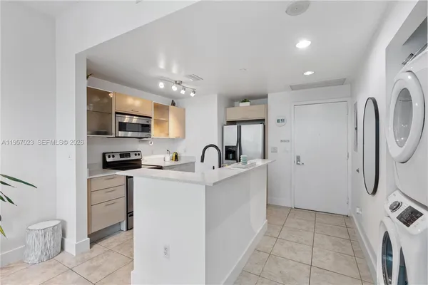 a kitchen with stainless steel appliances granite countertop a refrigerator and a stove top oven
