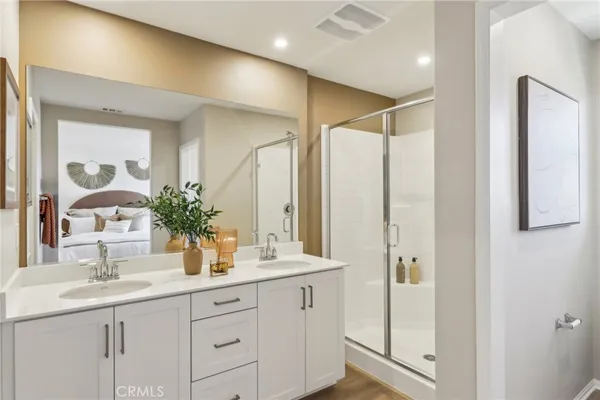 a bathroom with a double vanity sink and mirror