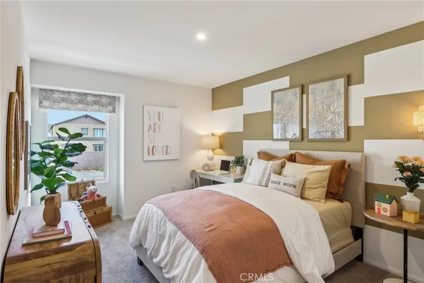 a bedroom with a bed and a potted plant