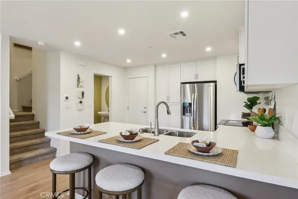a dining room with furniture and a chandelier
