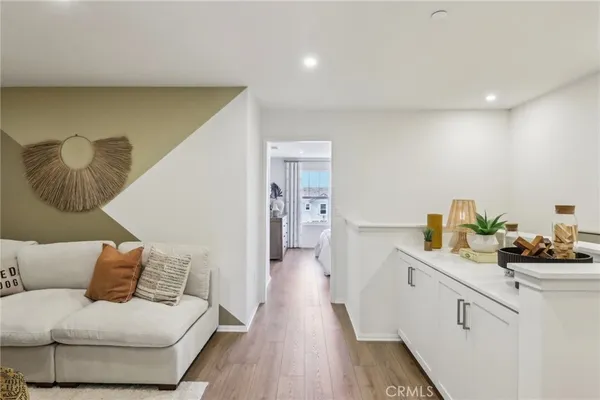 a living room with furniture and a wooden floor