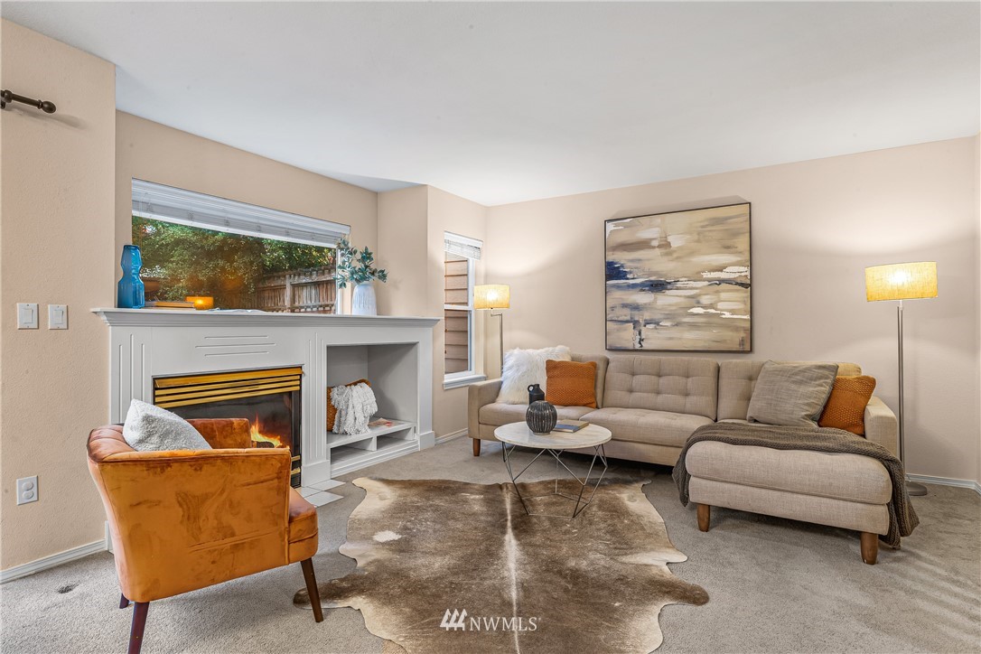 18704 20th Avenue Southeast Bothell, WA 98012 - Photo 2 of 27 a living room with furniture and a fireplace