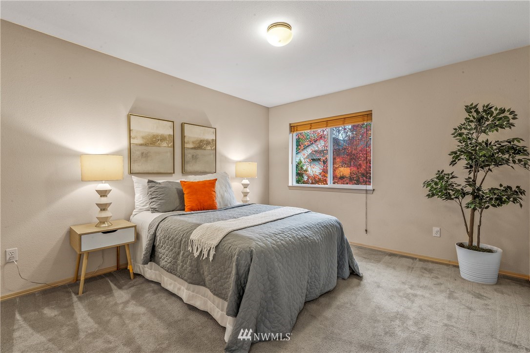 18704 20th Avenue Southeast Bothell, WA 98012 - Photo 15 of 27 a bedroom with a bed and a potted plant