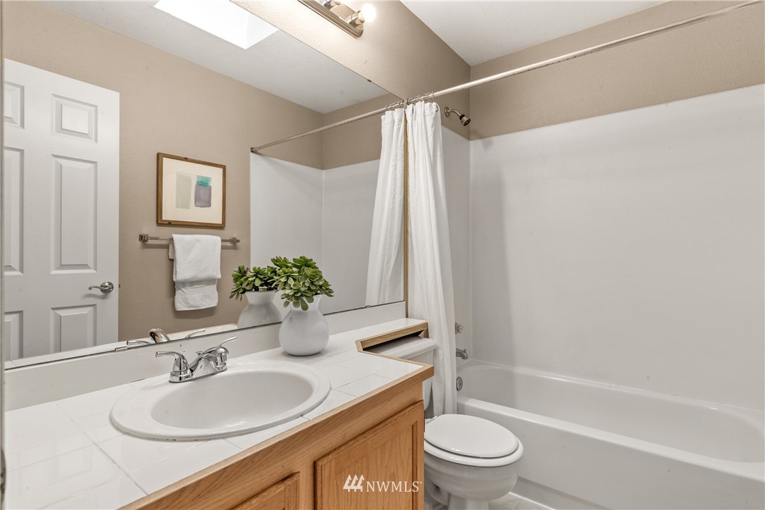 18704 20th Avenue Southeast Bothell, WA 98012 - Photo 18 of 27 a bathroom with a granite countertop sink toilet and shower