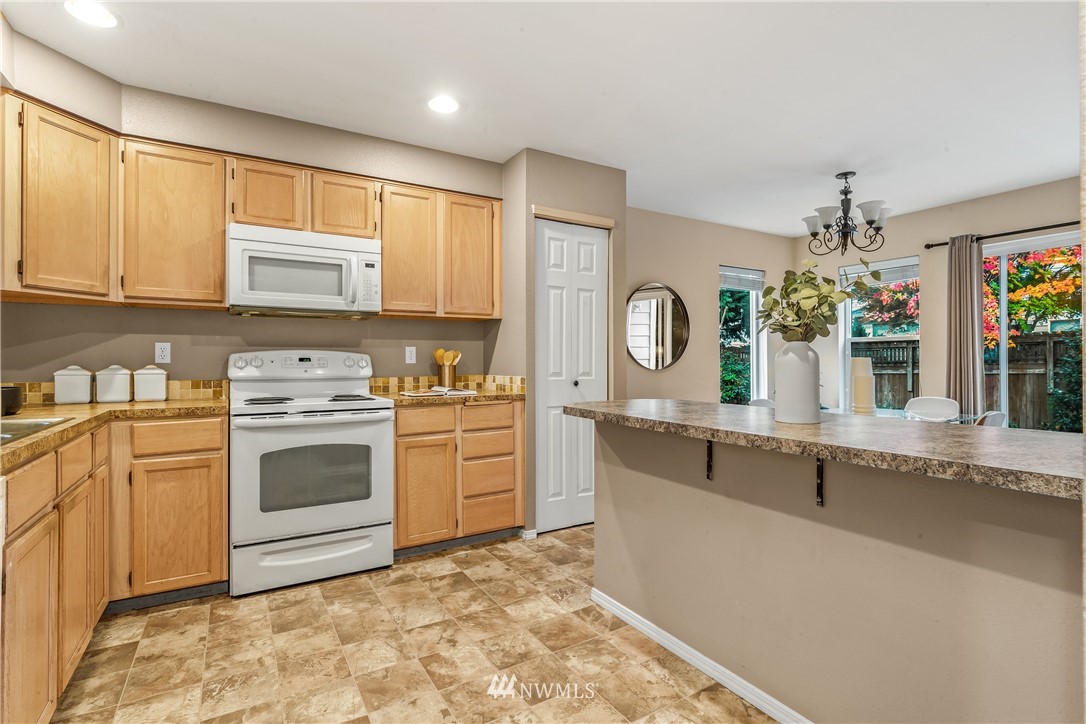 18704 20th Avenue Southeast Bothell, WA 98012 - Photo 4 of 27 a kitchen with stainless steel appliances granite countertop a stove a sink and a microwave