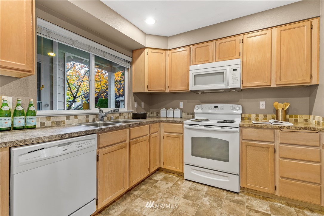 18704 20th Avenue Southeast Bothell, WA 98012 - Photo 5 of 27 a kitchen with granite countertop white cabinets and white appliances
