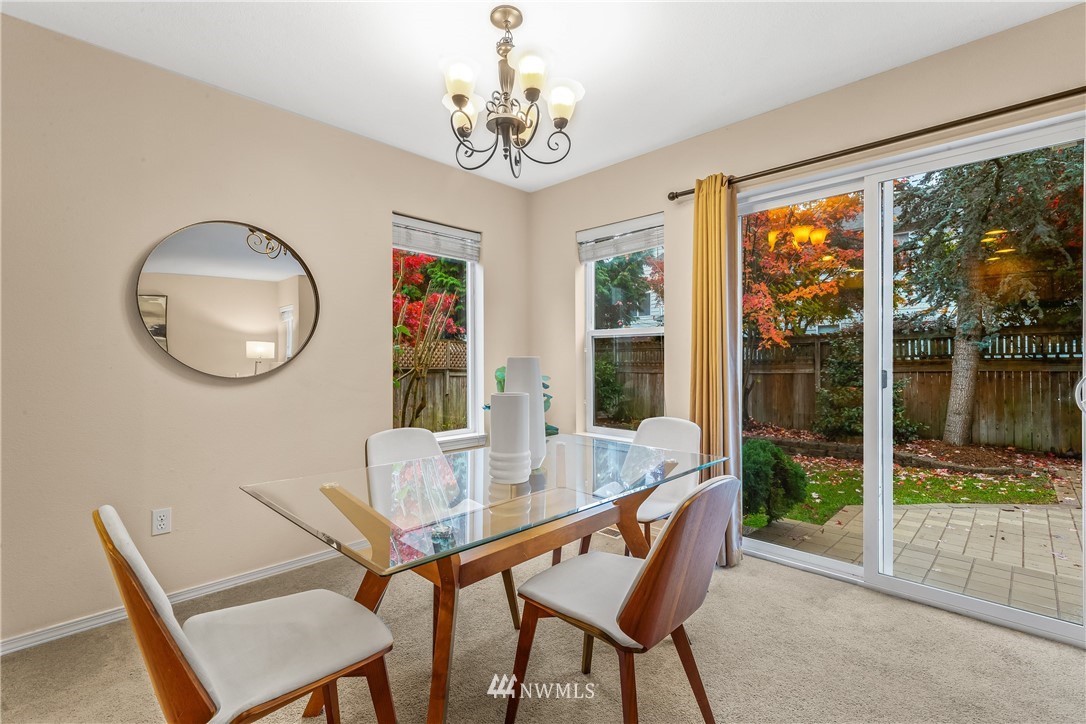 18704 20th Avenue Southeast Bothell, WA 98012 - Photo 8 of 27 a dining room with furniture a rug a potted plant and a chandelier